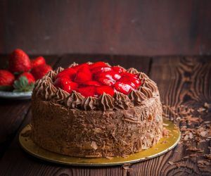 Strawberry, chocolate fruit cake and fresh strawberry on wooden table 1